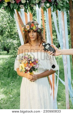 Photographer Measuring Light With Light Meter On Beautiful Girl.