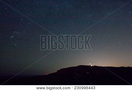 Well-known Landmark Belle Tout Lighthouse On The Sussex Coast, With Starry Sky, Red Glow On Horizon 
