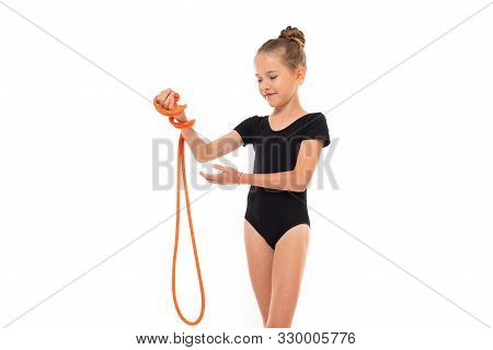 Picture Of Girl Gymnast In Black Trico In Full Height Keep A Jumping-rope In Her Hand.