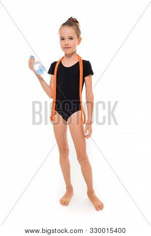 Picture Of Girl Gymnast In Black Trico In Full Height With A Jumping-rope Around Her Neck And A Bott