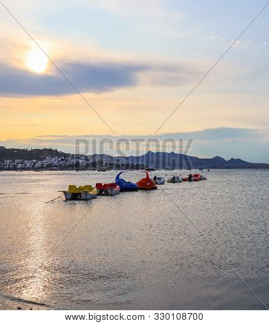 Beautiful Sunset On Aegean Coast With Islands And Mountains, Boats And Catamarans
