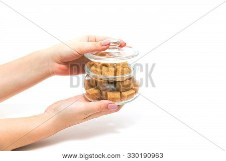 Sugar Cubes In A Glass Jar. Jar Of Sugar In The Hands Of A Girl On A White Background.