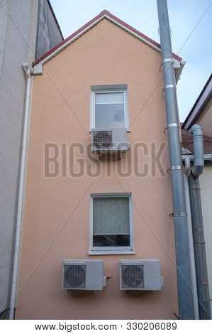 The Facade Of The Building With Windows And Air Conditioning.