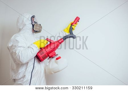Pest Control Worker Spraying Pesticides With Sprayer In Apartment Copy Spase White Walls Background