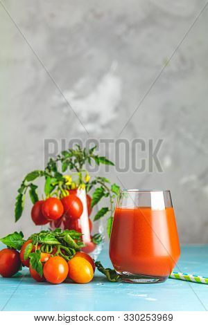 Glasses Of Fresh Delicious Jummy Red Tomato Juice And Fresh Raw Tomatoes With Pink Salt In Spoon On