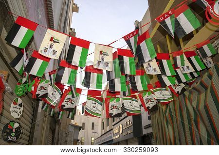 Dubai / Uae - October 25, 2019: Many Uae Flags On Old Dubai City Background. Old Dubai Street Decora
