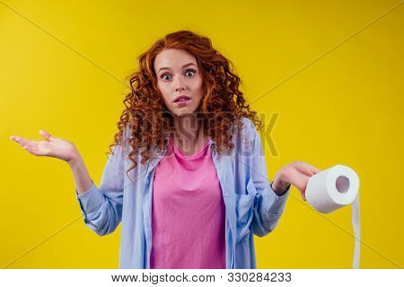 Beautiful Curly Redhead Ginger Woman Holding Eco Toilet Paper Roll On Yellow Color Background