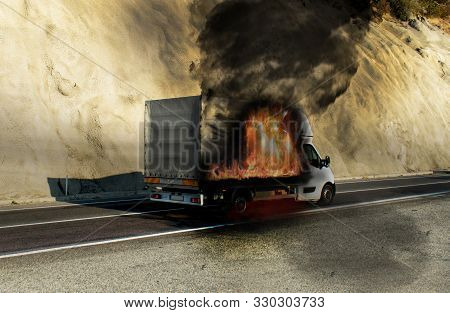A Semi-truck On The Street In Fire. Truck Carrying Goods In Flames.  Fire Struck The Truck. Danger O