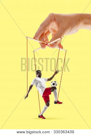 Man Like A Puppet In Somebodies Hands On Yellow Background. Concept Of Unfair Manipulation, Phycolog