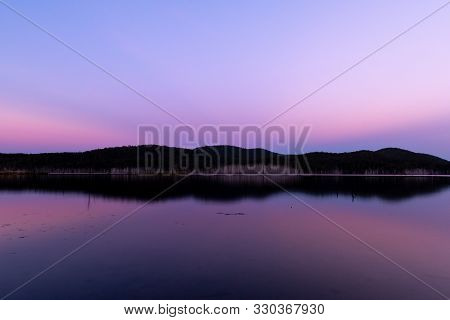 A Perfect Reflection During A Pink Sunset A Lake On A Clear And Sunny Day In Queensland, Australia.