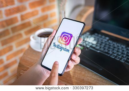 Chiang Mai, Thailand - Oct.18,2019: Woman Holding Xiaomi Mi Mix 3 With Instagram App  On Screen At C