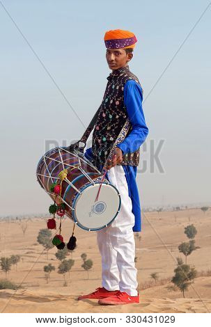 Bikaner, India - January 12, 2019: Indian Drummer In Traditional Clothes Performing During Camel Fes