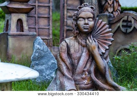 Statue Of A Japanese Woman Holding Uchiwa The Hand Fans Used In Japan. Mythology Concept