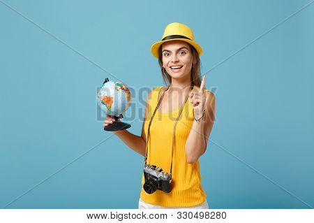 Traveler Tourist Woman In Yellow Summer Casual Clothes, Hat With Globe, Camera Isolated On Blue Back