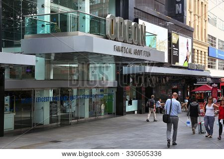 London, Uk - July 7, 2016: People Walk By Odeon Cinema At Leicester Square In London, Uk. London Is 