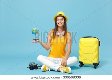Traveler Tourist Woman In Yellow Casual Clothes, Hat With Suitcase Photo Camera Isolated On Blue Bac