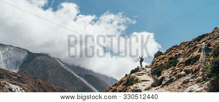 Hiker Man Silhouette On Clouds Background Standing On Path Going Over The Imja Khola Valley During A
