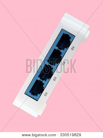 White 8 Port Plastic Ethernet Switch Isolated On Pink Background At Dry Day
