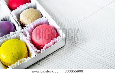 Macarons Isolated On A White Wooden Background...