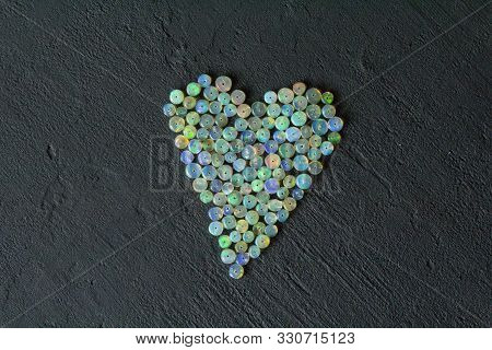 Opals Gemstone From Ethiopia Lies On Black Background. White Fire Opals With Rainbowlike Fire. Natur
