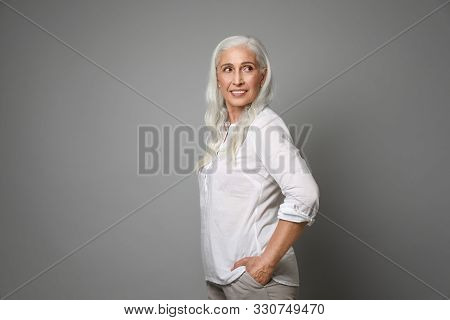 Portrait Of Beautiful Mature Woman On Grey Background
