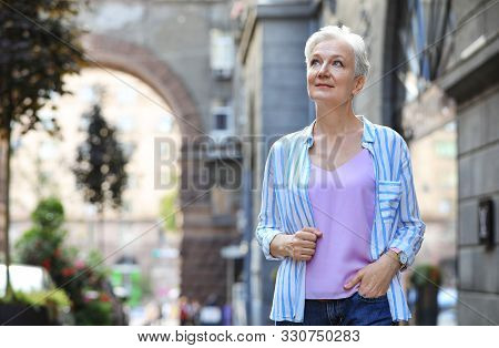 Happy Mature Woman On City Street, Space For Text. Smart Aging
