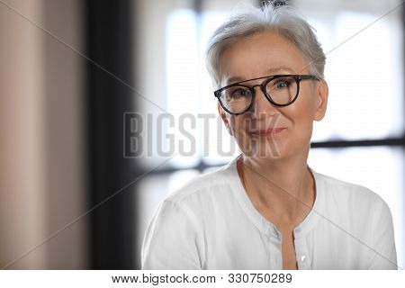 Happy Mature Woman In Glasses Indoors, Space For Text. Smart Aging