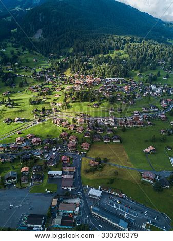 Sun Shines Over Swiss Village Grindelwald After Heavy Storm In Summer Time Near Swiss Alps
