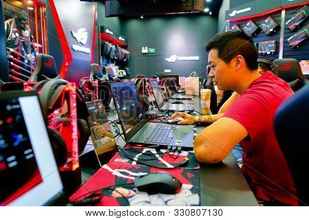 SHENZHEN, CHINA - CIRCA APRIL, 2019: a man using a laptop at Asus ROG Store in Shenzhen. Republic of Gamers is a brand used by Asus.