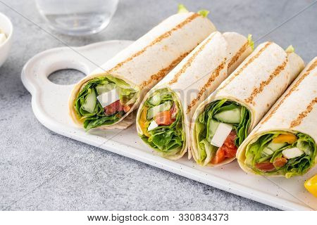 Wrap Sandwich, Roll With Fish Salmon, Vegetables And Cheese. Grey Background. Close Up.
