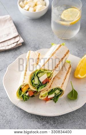Wrap Sandwich, Roll With Fish Salmon, Vegetables And Cheese. Grey Background. Close Up.