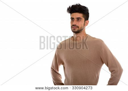 Studio Shot Of Young Persian Man Thinking While Looking At Dista