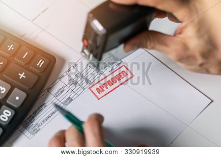 Tender Acceptance - Hand Put A Approved Stamp On Financial Bill