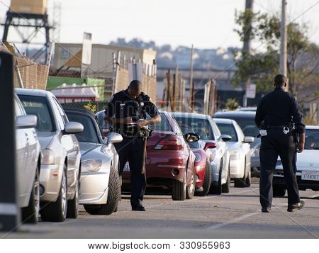 San Francisco  - October 9, 2011:  Sfpd Police Officers Write Parking Tickets For Cars Along Street 