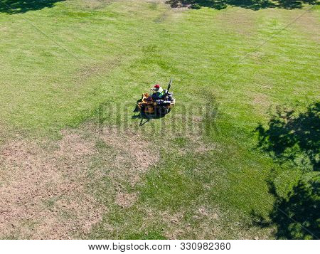 Aerial View Of Lawn Care Riding Mower At The Square Park, Ladera Ranch. California.