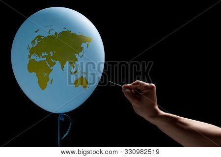 Balloon In The Form Of Planet Earth. A Man With A Needle In His Hand Will Blow Up The World. The Con