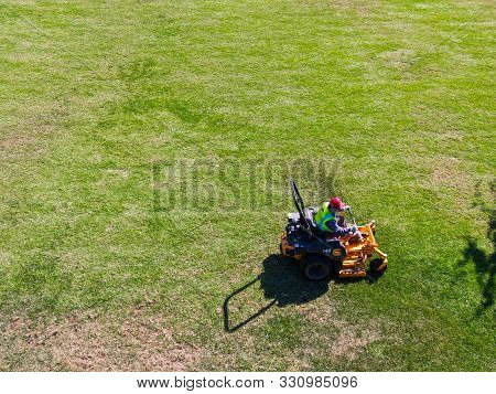 Aerial View Of Lawn Care Riding Mower At The Square Park, Ladera Ranch. California.