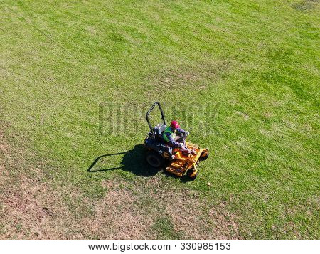 Aerial View Of Lawn Care Riding Mower At The Square Park, Ladera Ranch. California.