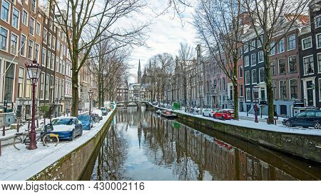 City scenic from a snowy Amsterdam in winter in the Netherlands