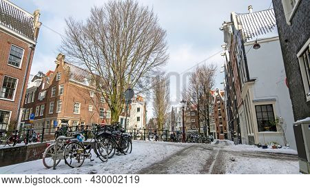 City scenic from a snowy Amsterdam in winter near the Nieuwmarkt in the Netherlands