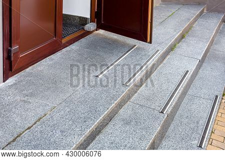 Granite Threshold At The Open Brown Entrance Door With Rubber Non-slip Strips On Steps Of Building C