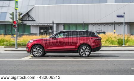 First Generation Of The New Range Rover Velar 2019 Model. Red Suv At Fast Speed Driving On City Road
