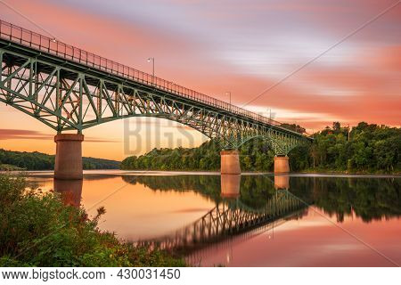 Augusta, Maine, USA view on the Kennebec River with Memorial Bridge at dawn.