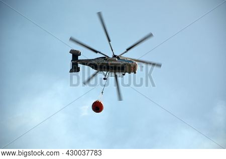 Russian KA-32 helicopter draws water from the sea to extinguish a forest fire. 30 July, 2021. Marmaris,Turkey