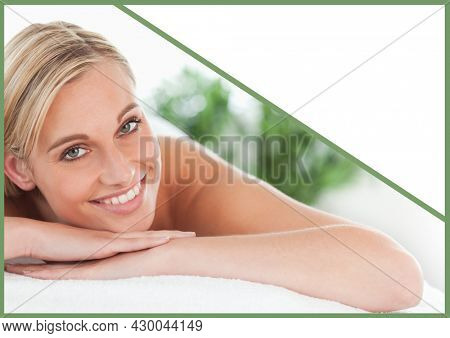 Composition of amiling woman lying on towel over white background. health and wellbeing template concept digitally generated image.