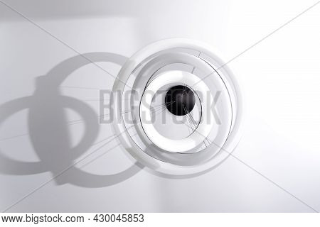 Modern Round White Chandelier With Led Lamps Hanging On The Ceiling In The Interior