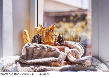 Corns, Autumn Leaves, Pine Cones And Coffee Cup On Windowsill. Creative Autumnal Background Near The