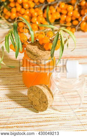 Hippophae Sea Buckthorn Cosmetic Oil In A Glass Bottle With A Pipette On A Background With Copy Spac