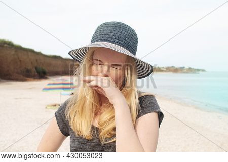 The Girl In The Hat Is Allergic To The Sun. Close-up Of A Hand And A Handkerchief. Spoiled Vacation 
