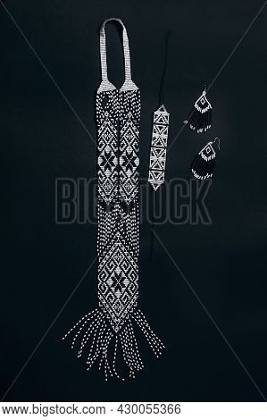 White And Black Traditional Gerdan With Handmade Beaded Earrings On A Black Background.